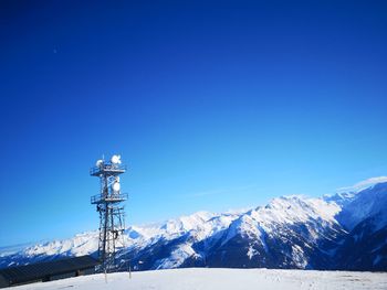 Snowcapped mountains against clear blue sky