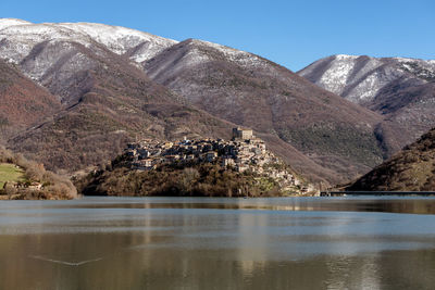 Scenic view of lake and mountains against sky