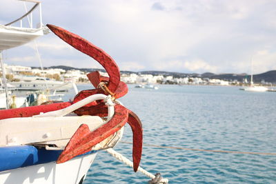 Close-up of red ship in sea against sky