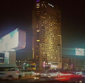 Illuminated cityscape against sky at night