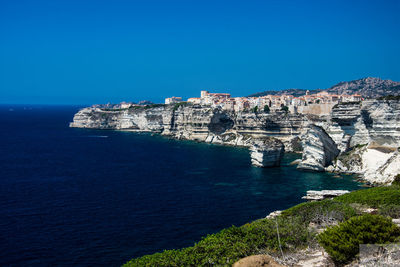 Scenic view of sea against clear blue sky