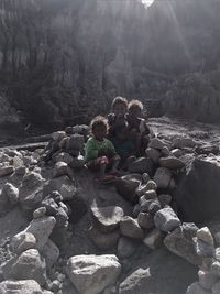 High angle view of people sitting on rocks