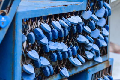 Close-up of padlocks hanging on railing