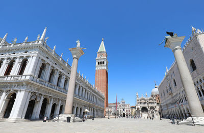 Buildings in city against clear sky