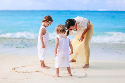 Rear view of women on beach