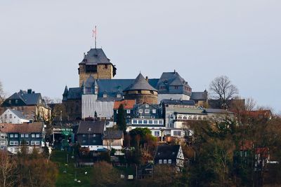 Buildings in city against clear sky