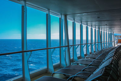 View of blue sea against sky seen through window