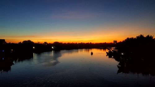 Scenic view of lake against romantic sky at sunset