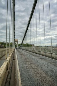 Bridge over river against sky in city