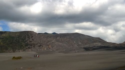 Scenic view of mountains against cloudy sky