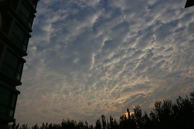 Buildings against cloudy sky