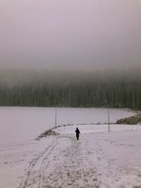 Scenic view of snow covered field against sky