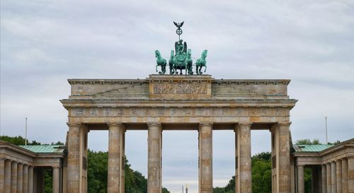 Low angle view of statue against cloudy sky