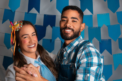 Portrait of smiling couple standing in office