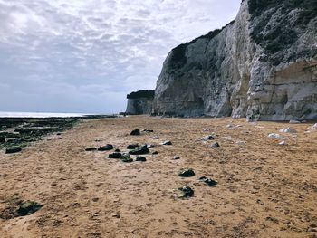 Rocks on beach against sky