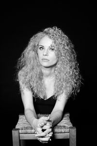 Portrait of a beautiful young woman over black background