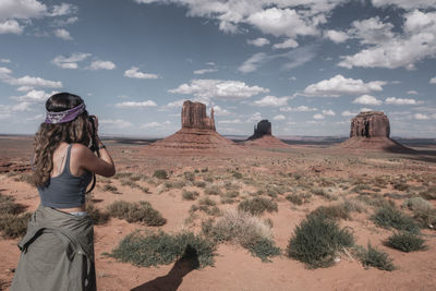 Panoramic view of woman on desert against sky. shooting
