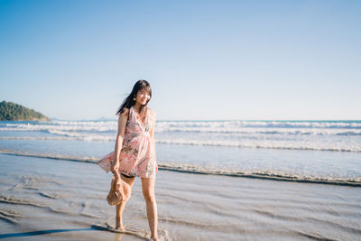 Smiling woman at beach during summer vacation