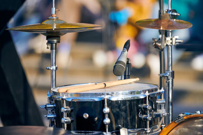 Drum kit at outdoor rock party, drumsticks on tom-tom drum. drum set with drum sticks