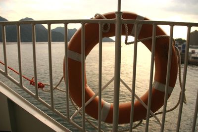 Close-up of metal railing against sea