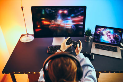 Teenager girl playing video game. gamer playing championship tournament. competition and having fun