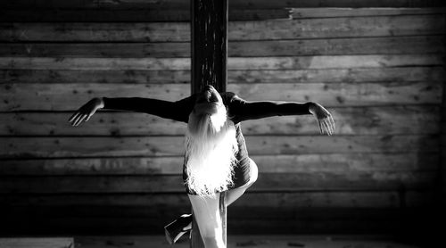 Young woman posing on pole