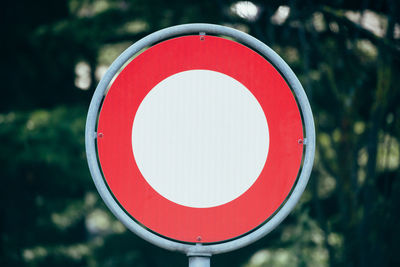 Close-up of road sign against trees