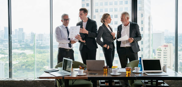 Group of people using mobile phone at table