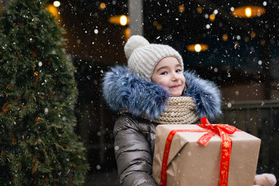 Portrait of smiling young woman in warm clothes