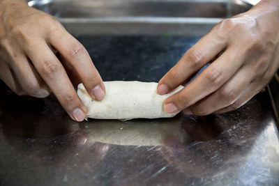 Close-up of person preparing food on table