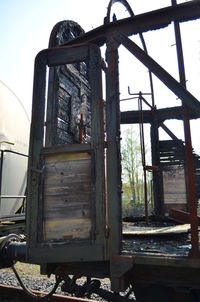 Close-up of abandoned car against sky