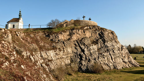 Low angle view of rock formations against sky