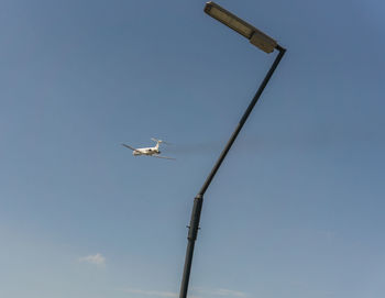Low angle view of airplane against clear sky