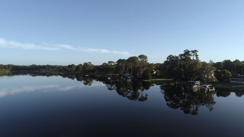 Reflection of trees in lake against sky