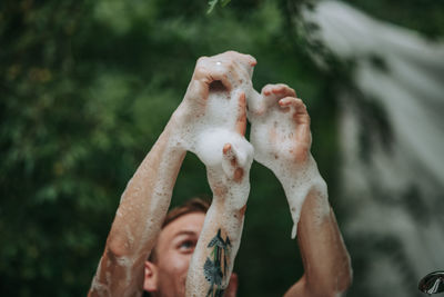 Close-up of man hand on wet outdoors