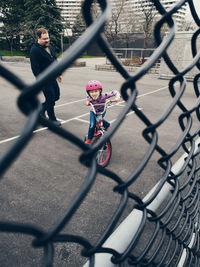 Children playing with chainlink fence