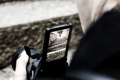 Close-up of hand holding mobile phone