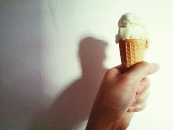 Cropped image of hand holding over white background