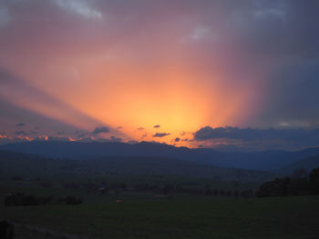 Scenic view of field against sky during sunset