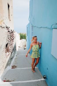 Full length of young woman against sky