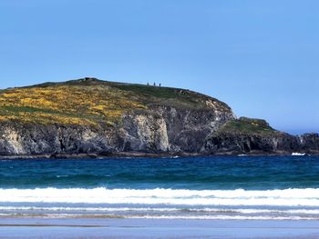Scenic view of sea against clear blue sky
