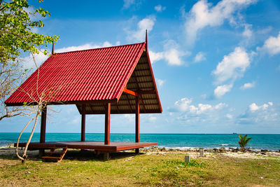 Lifeguard hut on beach by sea against sky