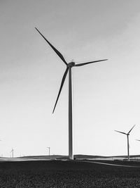 Windmills against sky