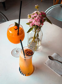 High angle view of orange rose on table