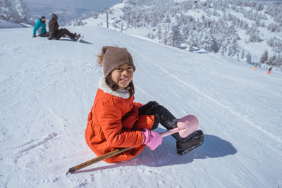 Portrait of woman skiing on snow