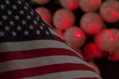 Close-up of flags against blue wall