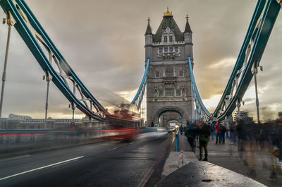 View of suspension bridge against cloudy sky