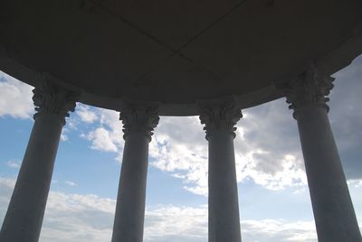 Low angle view of colonnade against sky