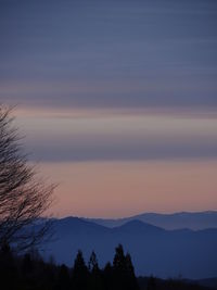Scenic view of silhouette mountains against sky at sunset