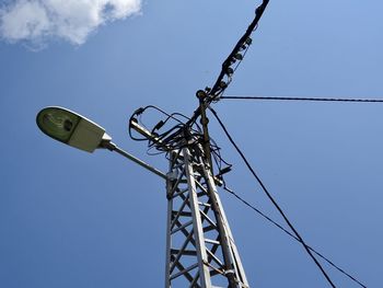 Low angle view of electricity pylon against sky